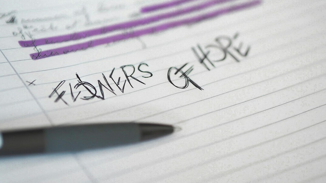 Close-up of printed survey questionnaires with a pen